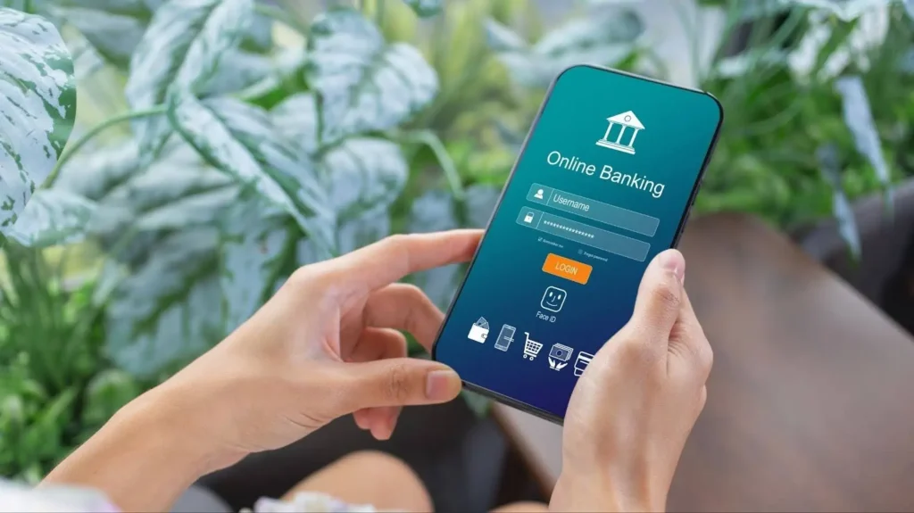 woman holding phone with banking app login screen
