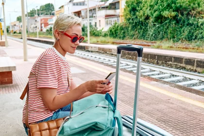 Woman applying for a Same Day Loan while waiting for train on holiday | Swoosh Finance NZ