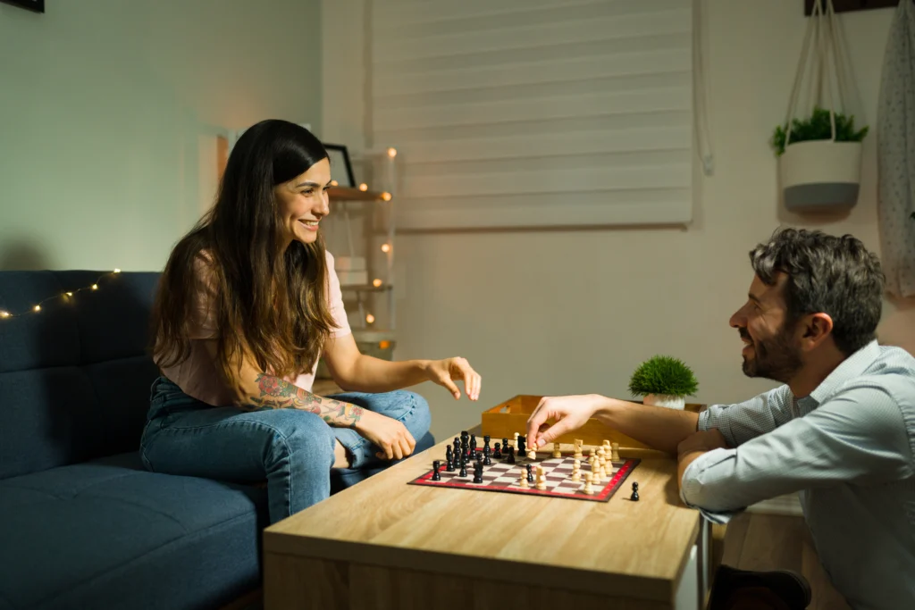 Couple playing chess together