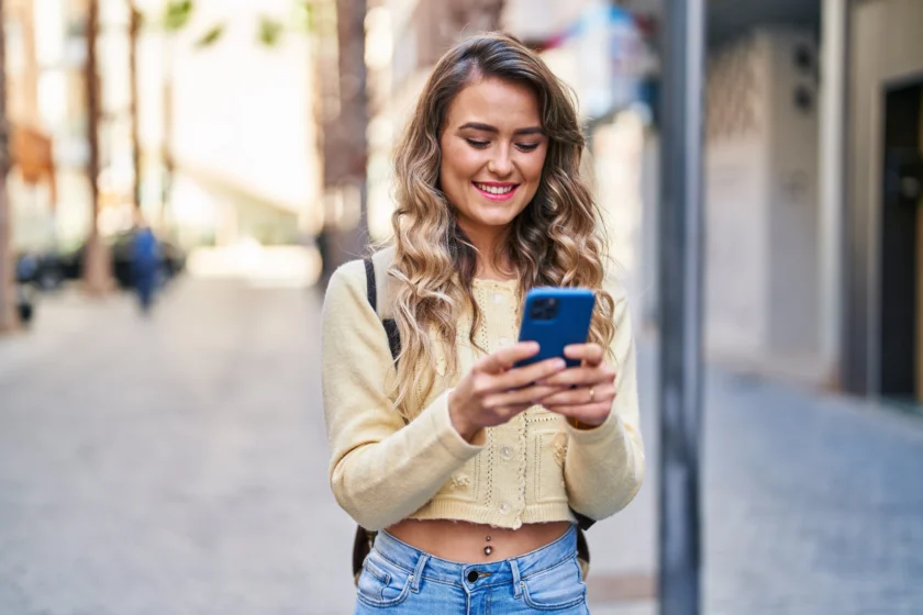 Woman on her phone applying for a debt consolidation loan with Swoosh NZ