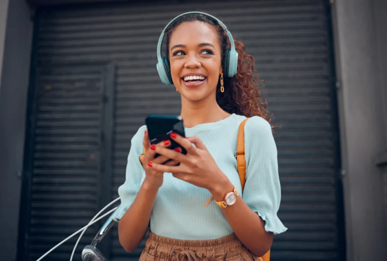 Woman on a walk outside smiling on her phone as she applies for a short-term loan