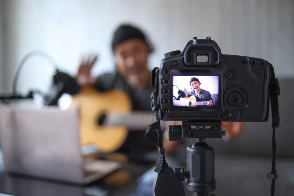 Man waving to the camera as a films a YouTube video to make money online